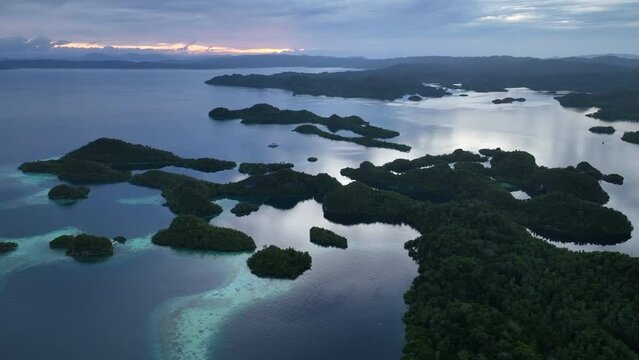 Daybreak illuminates the beautiful limestone islands of Pef in Raja Ampat, Indonesia. This remote, tropical region is known to harbor the world's greatest marine biodiversity.