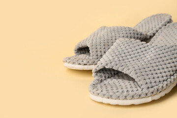 Grey slippers on yellow background