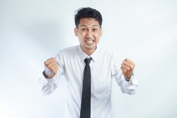 Young Asian business man showing happy excited expression with clenched fist