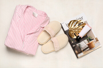 White slippers, pajamas and magazine on white background. Top view