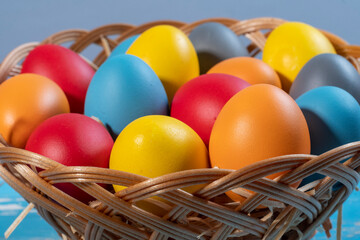 easter basket with straw and colored eggs