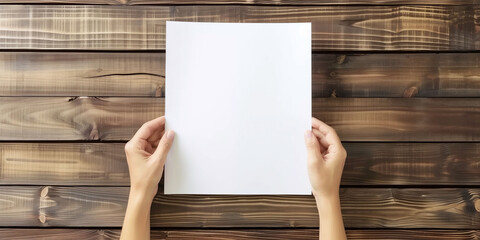 Blank White Paper Held Against a Wooden Background