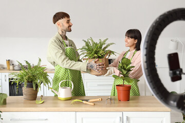 Couple of bloggers with plants recording video at home