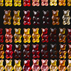 Seamless pattern of gummy bears on black background