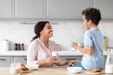 Mother and son enjoying breakfast together in kitchen