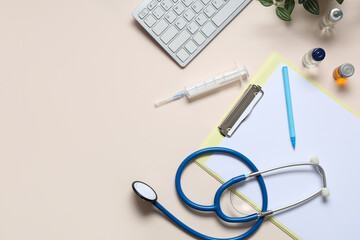 Clipboard with medical supplies and computer keyboard on beige background. World Health Day