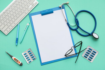 Blank clipboard with medical supplies and computer keyboard on green background. World Health Day