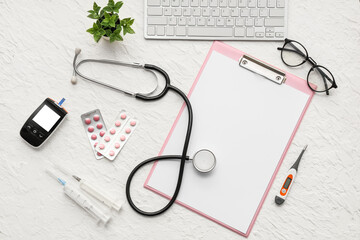 Blank clipboard with medical supplies and computer keyboard on white background. World Health Day