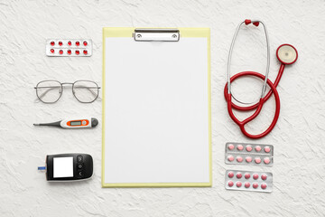 Blank clipboard with medical supplies on white background. World Health Day
