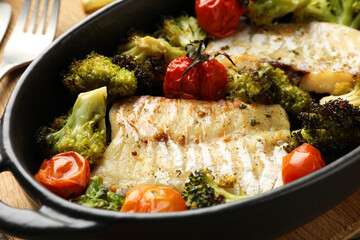Tasty cod cooked with vegetables in baking dish, closeup