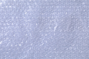Transparent bubble wrap on gray background, top view