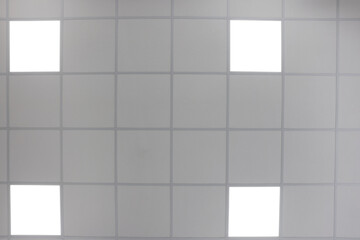 White ceiling with PVC tiles and lighting indoors, bottom view