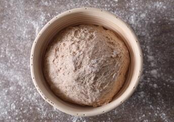 Fresh sourdough in proofing basket on table, top view