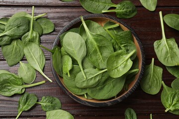 Fresh spinach leaves on wooden table, flat lay