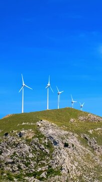 Green renewable alternative energy concept - wind generator turbines generating electricity. Wind farm on Crete island, Greece