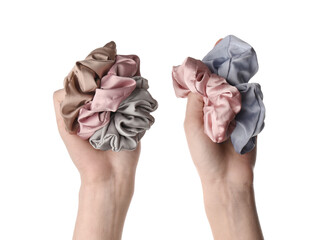 Female hands with trendy silk scrunchies on white background