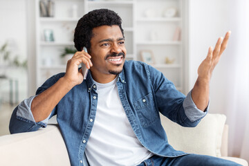 Man laughing during a phone call at home