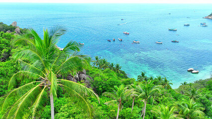 Koh Tao offers serene beaches, lush jungles, and laid-back vibes, inviting travelers to unwind in its tranquil natural beauty. Drone aerial view. Ocean background.
