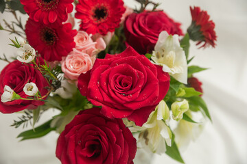 Close-up of water droplets on rose petals in a bouquet