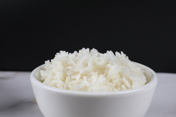 Thai Jasmine Rice in white bowl on table. Realistic Asian healthy food element.  