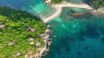 Discover the epitome of natural beauty on our stunning island haven. Crystal-clear waters, vibrant coral reefs, and lush greenery await your exploration. Drone aerial view. Koh Tao, Southern Thailand.