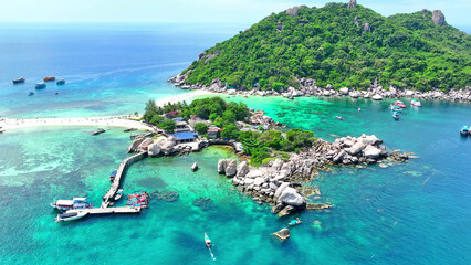 Embark on a journey to an enchanting island oasis, where lush jungles meet pristine beaches, and every corner reveals a breathtaking vista. Flight over the ocean. Koh Nangyuan, Thailand.
