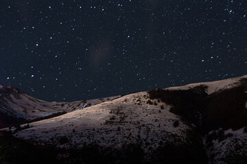 Snowy mountains in dark night with stars - Patagonia Bariloche Argentina