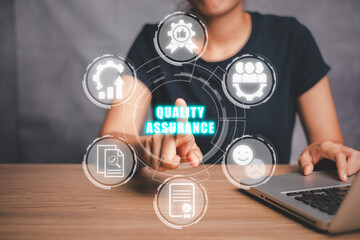 Quality assurance concept, Businesswoman hand touching qguarantee, improvement, development, testing, satisfaction and standard icon on virtual screen.