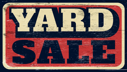Aged and worn yard sale sign on wood
