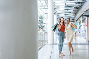 Portrait of Asian attractive two girl shopping indoor in shopping mall. 