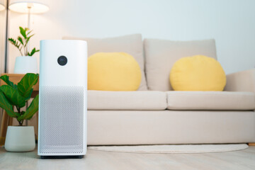 Air Purifier in cozy living room. Purification system for filter and cleaning or removing dust PM2.5 HEPA and virus in home. Allergy, Pure air, health lifestyle, Wellness life and Air Pollution