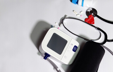 Medical device and medicine with a white background. Blood pressure monitor Heart disease diagnosis...