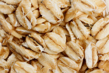 macro photography of a portion of Raw organic oat flakes covering the entire background. image for packaging