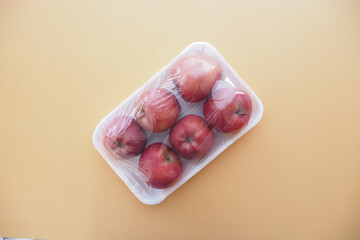 apples wrapped in transparent plastic. 