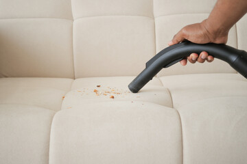  Cleaning Sofa with Vacuum Cleaner in living room