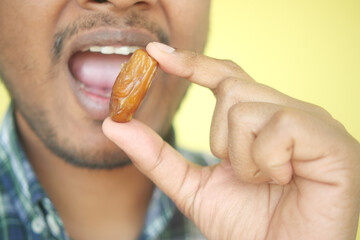 Close up of hand holding a date fruit 