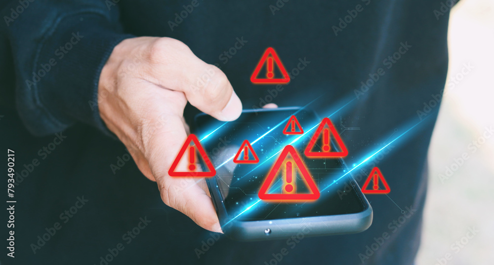 Aufkleber notification smartphone concept. a young man using a phone with a warning symbol indicating the risk