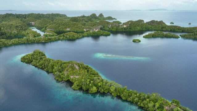 Early morning light illuminates the beautiful limestone islands of Pef in Raja Ampat, Indonesia. This remote, tropical region is known to harbor the world's greatest marine biodiversity.