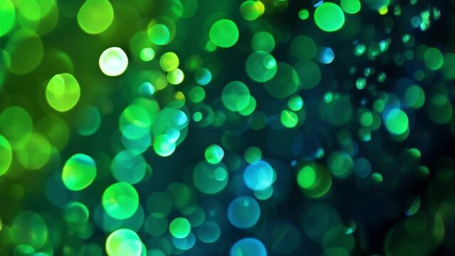 With a hypnotic effect defocused lights in electric greens and blues dance against a jet black surface evoking the energetic and electrifying atmosphere of a techno party. .