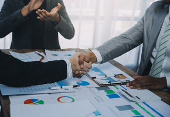Business people accept or confirm project on the proposal and join shaking hands at office.