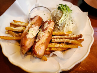 Potato fries and sausages on a plate