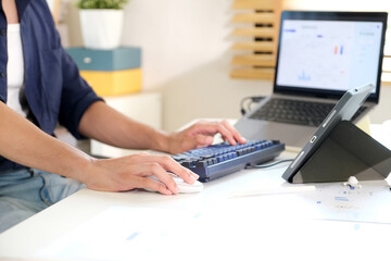 Closeup of man hand typing keyboard computer at home office