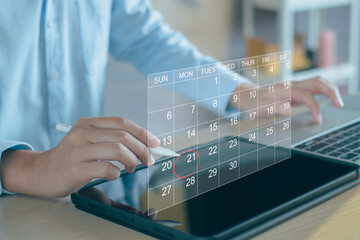 Calendar on the virtual screen interface. Businessman manages time for effective work.  Highlight appointment reminders and meeting agenda on the calendar. Schedule management concept.