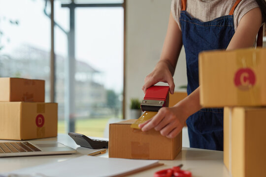 Close Up A Woman Entrepreneur Working At Home Office And Prepare A Parcel Before Delivery