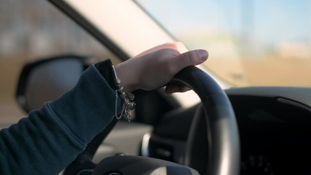 a woman's hands operating a modern car's controls. Highlighting advanced features like touchscreen displays, voice commands, or adaptive cruise control, this video sparks interest in automotive innova