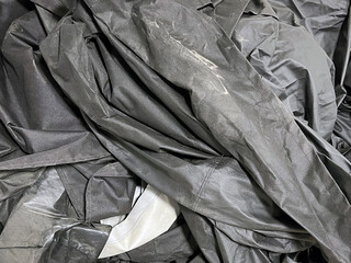 A large crumpled black tarp