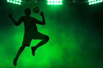 3d illustration shadow silhouette of young professional soccer player jumping in empty stadium at night