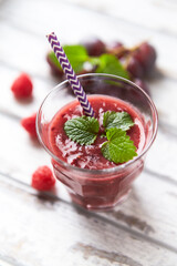 Fresh smoothie in a glass. Bright wooden background. Close up.
