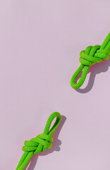 two ropes with secure knots. concept of reliability and safety. climbing rope with a knot lies on a colored background.