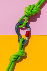 two ropes with secure knots are connected by a carabiner. Equipment for rock climbing and mountaineering. reliable connection. concept of reliability and strength.
